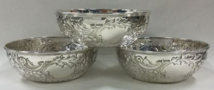 A good set of three chased silver bowls embossed with flowers. Sheffield 1916.