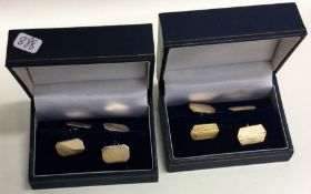Two boxed pairs of silver and gold plated cufflinks.