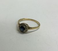 An 18 carat gold diamond mounted circular cluster ring. Approx. 2 grams