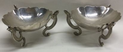 WANG HING: A pair of Chinese export silver dishes with dragon feet.