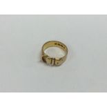 A small 18 carat gold buckle ring. Approx. 3 grams
