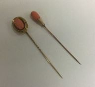 A good coral and gold stick pin together with one other. Approx. 10 grams.