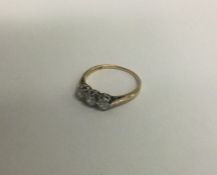 A good diamond three stone ring in two colour gold mount.
