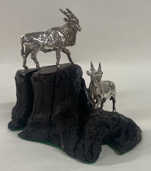 A pair of silver African antelope on a stand. Approx. 188 grams. Est. £200 - £300.