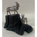 A pair of silver African antelope on a stand. Approx. 188 grams. Est. £200 - £300.