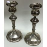 A pair of silver circular candlesticks. Birmingham. Est. £20 - £30.