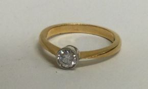 A good diamond single stone ring of circular form in collet mount. Approx. 0.5 carats.