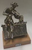 A large Judaica silver figure of a man playing violin on a roof.
