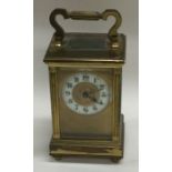 A small brass carriage clock together with an MOP card case.