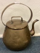 An Antique brass kettle with lift off lid.