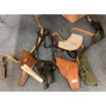 A collection of American and other pistol holsters.