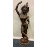 A large brass and copper mounted figure of an Eastern dancing lady.