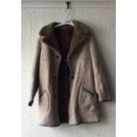 One sheepskin coat together with two other vintage coats.