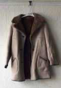 One sheepskin coat together with two other vintage coats.
