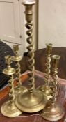 A set of five barley twist brass candlesticks.