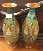 A tall pair of Royal Doulton vases.