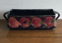 WILLIAM MOOCROFT: A rectangular twin handled trough with pomegranate design.