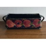 WILLIAM MOOCROFT: A rectangular twin handled trough with pomegranate design.