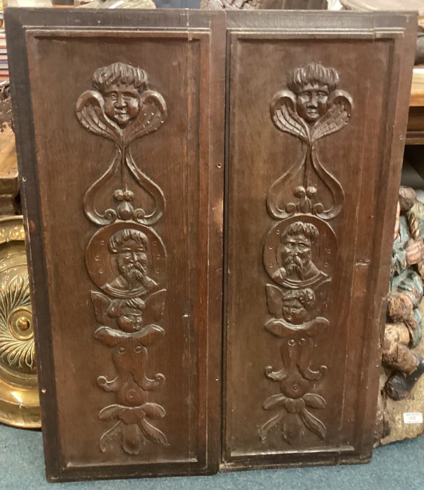 A good pair of carved oak panels decorated with figures.