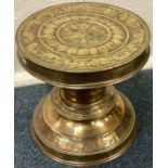 A large Antique circular brass stand attractively decorated with scrolls and flowers.