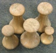 A set of five brass weights.