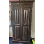 A narrow oak hall cupboard.