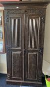 A narrow oak hall cupboard.