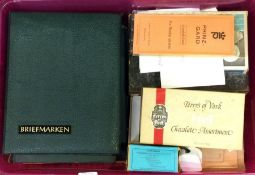 A box containing numerous stamps and albums.