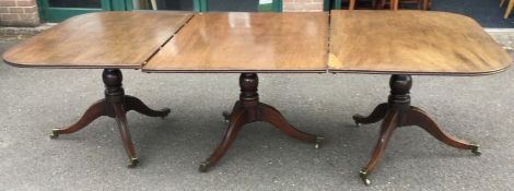 A good Georgian mahogany triple pillar table on reeded supports to brass feet.