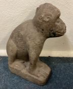 An Antique large stone model of a monkey with textured body in seated position.