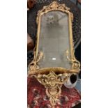 A large gilt framed mirror.