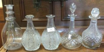 A group of five cut glass and other decanters. Est