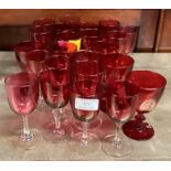 A collection of cranberry glasses.