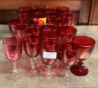 A collection of cranberry glasses.