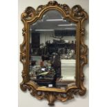 A large gilt framed mirror.