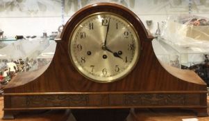 A large mahogany mantle clock.