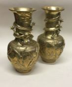 A pair of large brass vases of Japanese design.