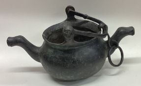 An unusual cast iron double lip swing handle cauldron.