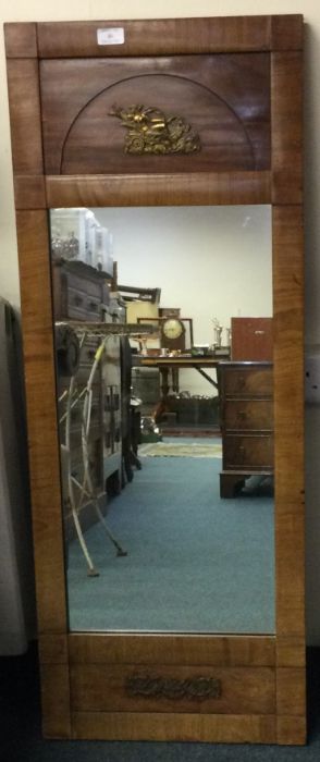 A Continental brass mounted mirror.