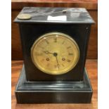 An old slate mantle clock with gilt dial.