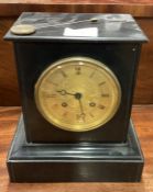 An old slate mantle clock with gilt dial.