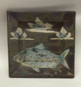 A square pottery bowl decorated with fish.