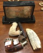 Two old pipes together with a scrimshaw etc.