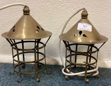 A pair of unusual brass light fittings with domed tops.