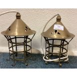 A pair of unusual brass light fittings with domed tops.