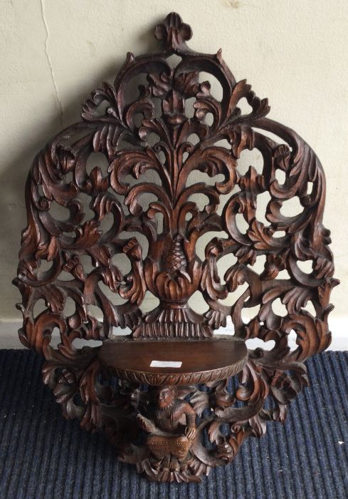 A large mahogany carved bracket with scroll decoration.