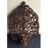 A large mahogany carved bracket with scroll decoration.