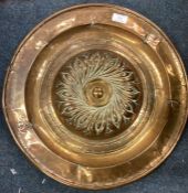 A good Antique brass alms dish with scroll decoration engraved with flowers.