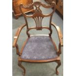 An Edwardian mahogany scroll back chair.