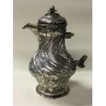 An 18th Century German silver chocolate pot chased with birds.